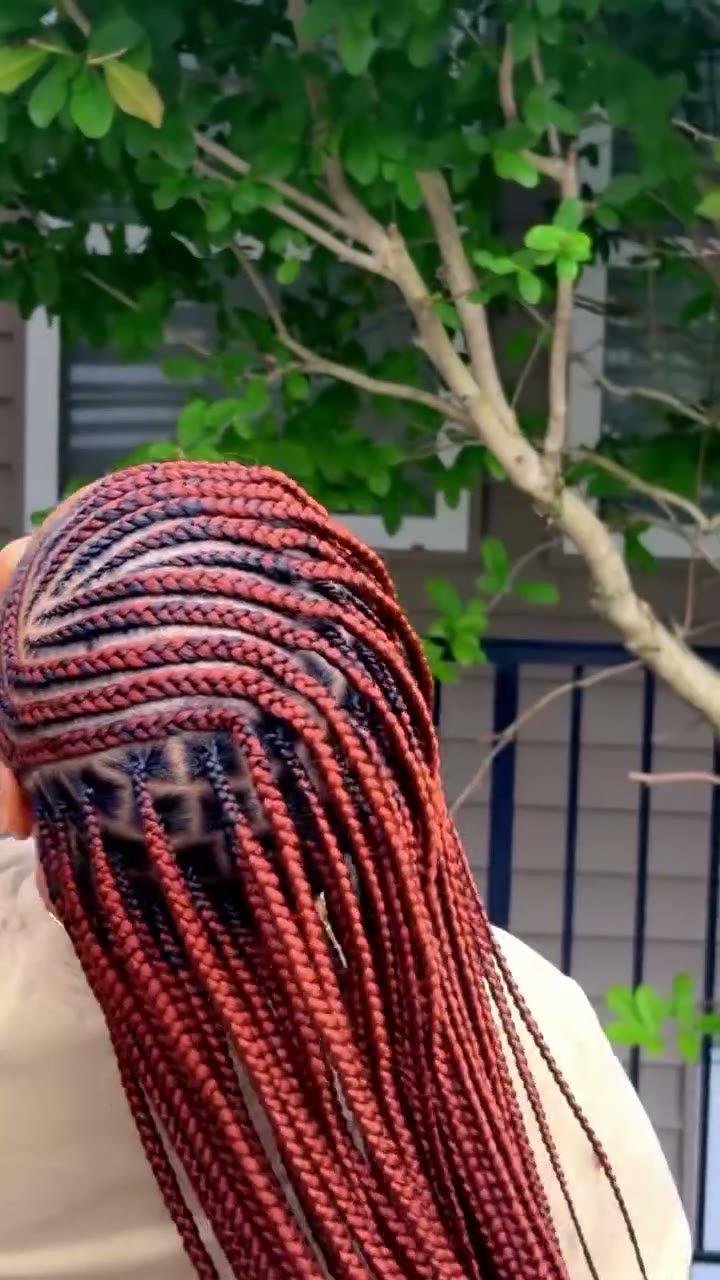 Burgundy feed-in cornrow braids with clean parting